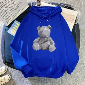 Detail of blue fleece hoodie featuring geometric bear print and front kangaroo pocket
