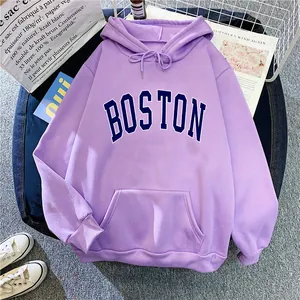 Detail of lavender hoodie featuring blue BOSTON embroidery and a soft cotton kangaroo pocket