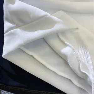 Detail showing soft fleece lining and tight ribbed cuffs of the white hoodie