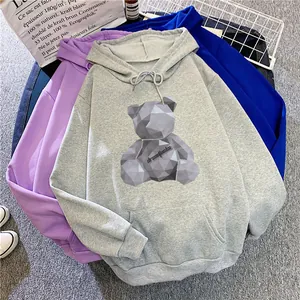 Detail of colorful hoodies featuring a geometric teddy bear print and front pocket