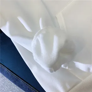 Detail shot of white fleece lining and ribbed cuff on a heavy cotton hoodie sweatshirt