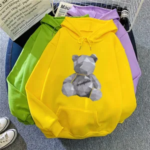 Detail of colorful hoodies with geometric bear print and ribbed cuffs in lifestyle setting