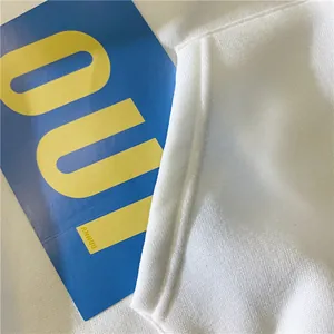 Close-up of white fleece hoodie pocket stitching and textured knit cotton fabric
