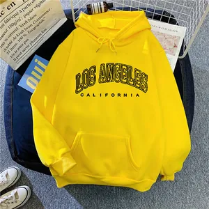 Detail of a bright yellow hoodie featuring black Los Angeles California letter print
