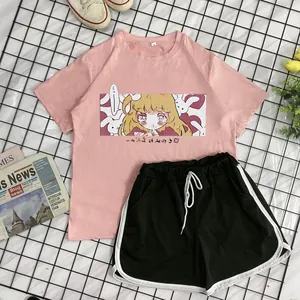 Detail of pink t-shirt with anime print and black athletic shorts with white piping