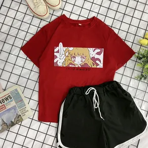 Detail of red cartoon print T-shirt and black side-striped shorts set on a checkered mat