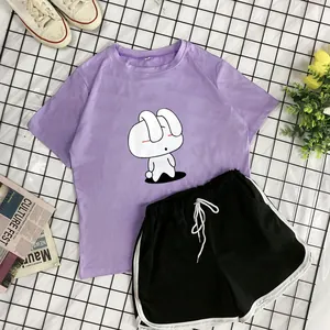 Flat lay of lavender bunny t-shirt and black drawstring shorts with white trim detailing
