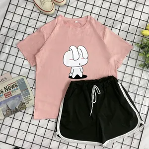 Detail of pink cotton t-shirt with cartoon rabbit print and black drawstring shorts set