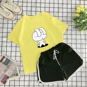 Flat lay of casual two-piece summer set featuring a yellow bunny T-shirt and green shorts