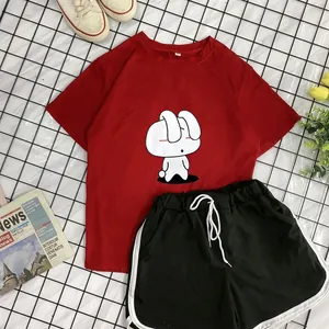 Flat lay of a red cotton T-shirt with bunny print and black drawstring sports shorts