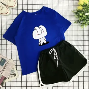 Flat lay of blue cotton T-shirt with bunny print and black sports shorts with drawstrings