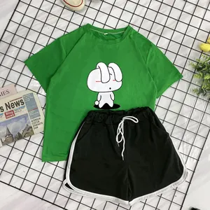 Detail of green T-shirt with bunny print and black shorts with white contrast trim