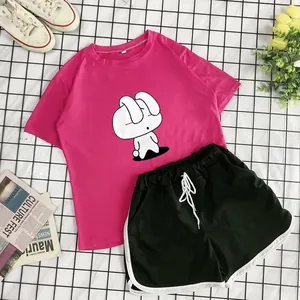 Flat lay of pink cotton T-shirt with rabbit print and black drawstring shorts