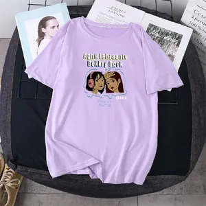 Flat lay detail of a lavender t-shirt featuring a cartoon girl illustration on cotton fabric