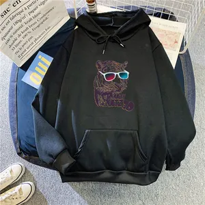 Detail of oversized black hoodie featuring a 3D tiger print and front kangaroo pocket