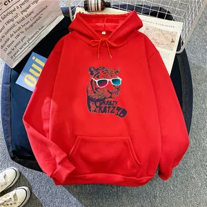 Oversized red hoodie with retro tiger print and kangaroo pocket in a stylish flat lay