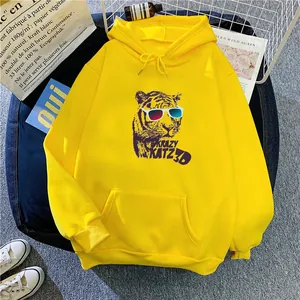 Close-up of bright yellow hoodie with 3D tiger print, kangaroo pocket and drawstring detail