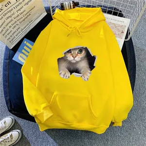 Detailed flat lay of a yellow oversized hoodie featuring a 3D cat print and white drawstrings