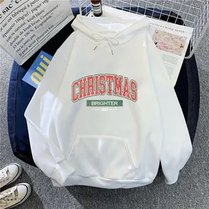 Close-up of white Christmas hoodie with red lettering on a lifestyle background