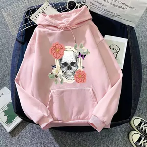 Detailed view of pink hoodie with skull and flower print on trendy mesh background