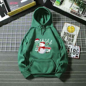 Detail shot of a dark green hoodie featuring a festive snowman print and Believe text