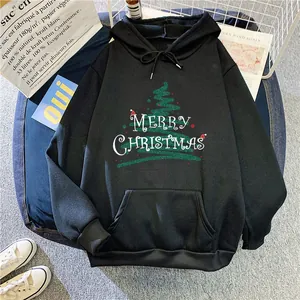 Detail view of a black Christmas hoodie with festive tree print and kangaroo pocket