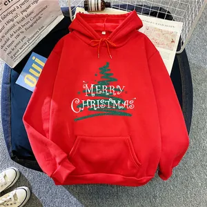 Flat lay of red Christmas hoodie with green tree graphic and Merry Christmas print