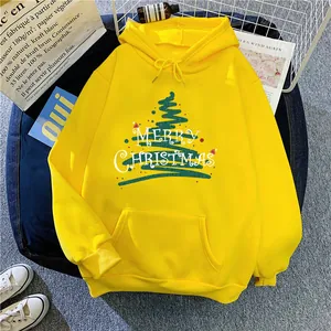 Flat lay of a yellow Christmas hoodie with a green tree print and kangaroo pocket