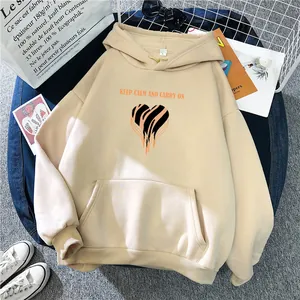 Detail of beige oversized hoodie featuring tiger heart print and kangaroo pocket