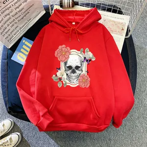 Detailed close-up of a red hoodie featuring a skull and floral print with a kangaroo pocket