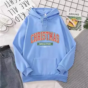 Flat lay of light blue Christmas hoodie with red and green text print and kangaroo pocket