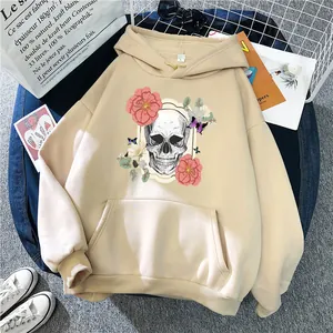 Oversized apricot hoodie with floral skull print on casual flat lay denim background