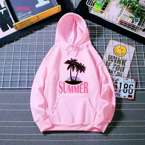 Detail of pink hoodie featuring palm tree sunset graphics and soft knitted fabric texture