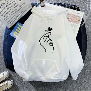 Close-up of heart print and kangaroo pocket on a white fleece-lined drawstring hoodie