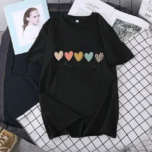 Detail of black cotton t-shirt featuring colorful heart prints and one day at a time text