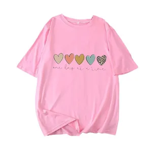 Pink crewneck t-shirt with heart graphic and one day at a time slogan for casual wear