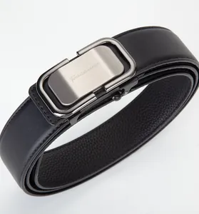 Detail of gunmetal brushed buckle and leather texture on mens automatic belt