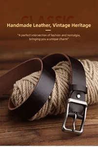 Detail of dark brown leather belt with matte metal buckle on vintage rustic wood background