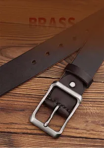 Detail of matte brushed zinc alloy buckle on dark brown premium leather men belt
