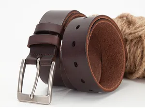 Detail of dark brown leather men's belt with silver metal pin buckle and retro texture