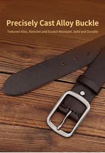 Detail of vintage brown leather belt with matte texture and brushed alloy buckle