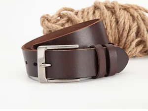 Detail of dark brown leather belt with matte silver buckle and textured rope accent