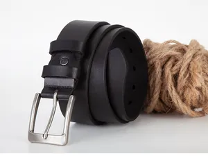 Close-up of black leather belt with silver brushed metal pin buckle on white background