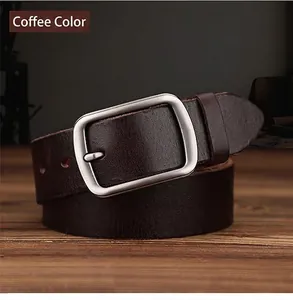 Detail of dark brown leather belt with matte silver buckle on a rustic wooden surface
