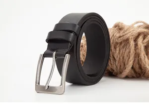 Macro detail of men's black leather belt with a brushed silver pin buckle on white
