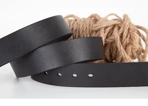 Macro detail of classic black leather belt showing grain texture and punch holes