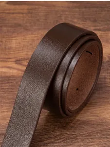 Macro shot of dark brown genuine leather belt texture on a dark wood background