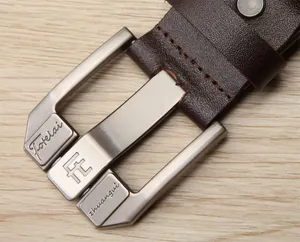 Close-up of dark brown leather belt with brushed metal buckle and fine stitching