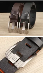 Close-up of black and brown genuine leather belts with brushed metal pin buckles