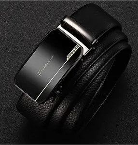 Macro shot of black lychee grain leather belt with metallic automatic buckle and gold pattern
